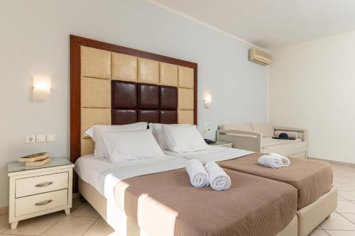 a bedroom with two beds with towels on them at Plaka Hotel II in Plaka