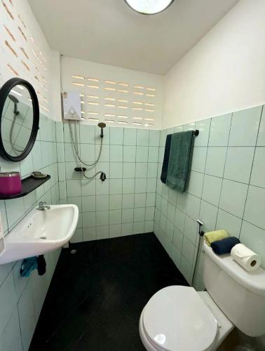 a bathroom with a white toilet and a sink at Firefly Bungalows Samui in Ban Bang Po