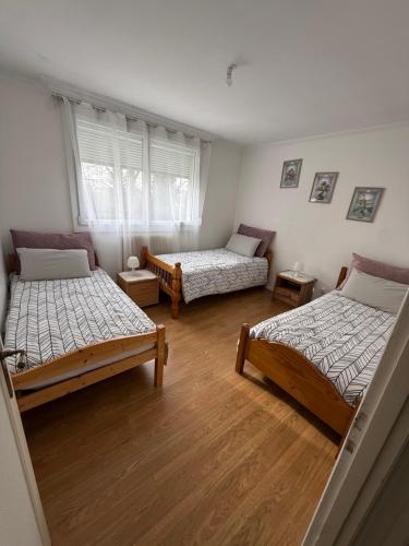a room with two beds and a window at Maison 4 à 8 personnes in Faches-Thumesnil