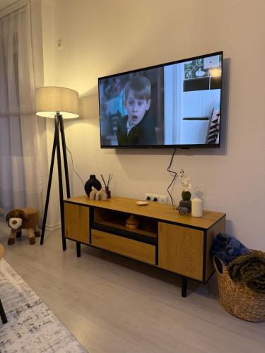 a living room with a television on a wall at Molly Nest in Gjakove