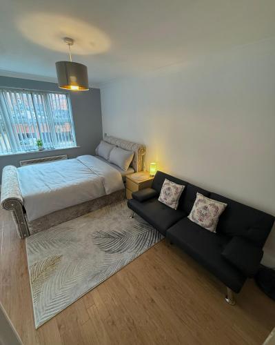 a living room with a bed and a couch at The Heart of Birmingham City Centre in Birmingham