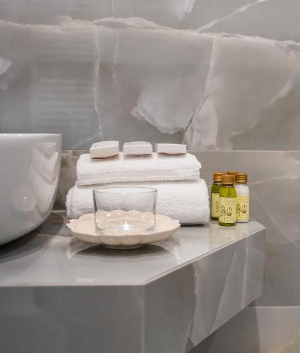 a table with towels and a plate on it at Hotel Biancamano in Rimini