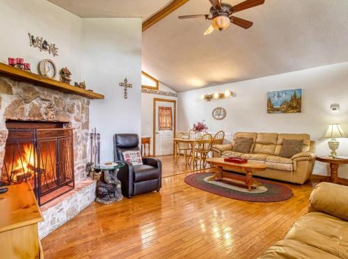 a living room with a couch and a fireplace at Amazing Grace-Cozy Cabin Retreat in the Smokies in Sevierville
