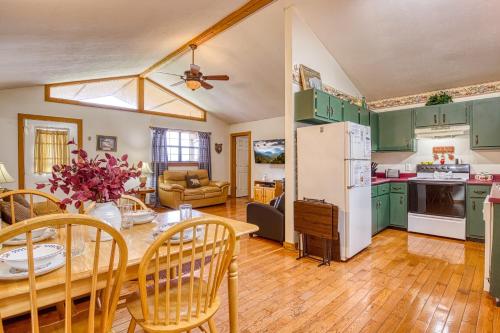 a kitchen and living room with green cabinets at Amazing Grace-Cozy Cabin Retreat in the Smokies in Sevierville