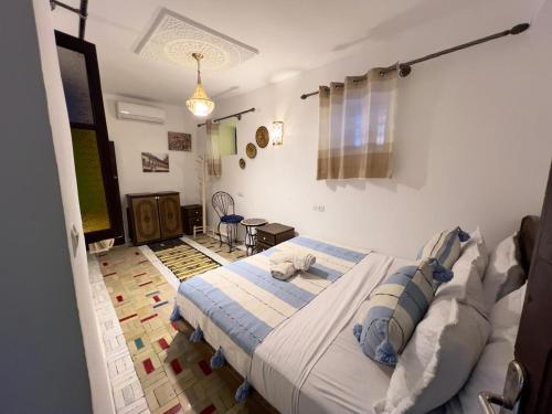 a bedroom with a large bed in a room at Dar Jnan EL Sbil in Fez