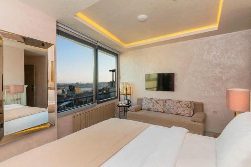 a bedroom with a bed and a large window at Ayramin Deluxe Hotel Taksim in Istanbul