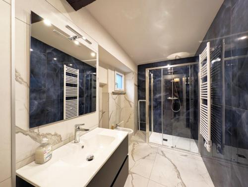 a bathroom with a sink and a shower at Le torri Virgo in Fossano