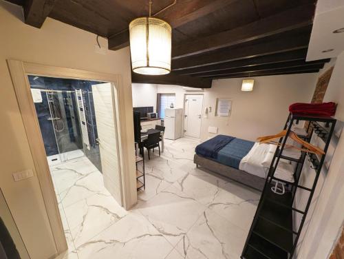 a bedroom with a bed and a desk in a room at Le torri Virgo in Fossano