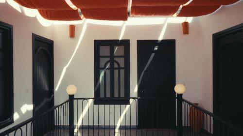a building with black doors and a string of lights at Nbta House in Tangier