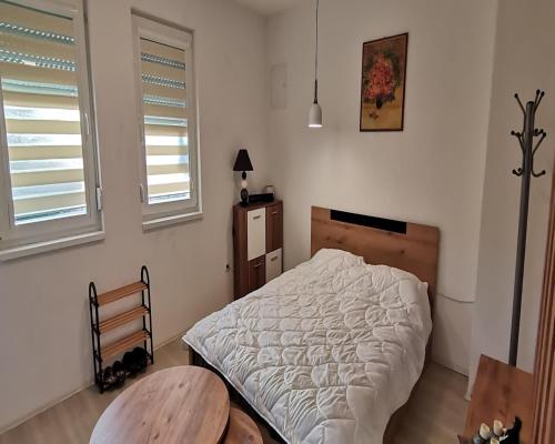 Llit o llits en una habitació de Labino Apartment