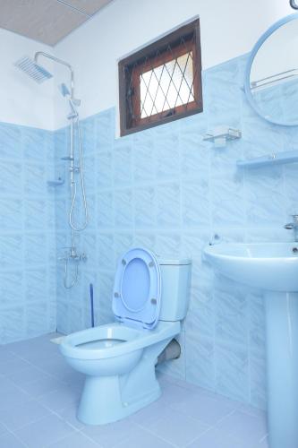 a bathroom with a toilet and a sink at Restora Ella in Ella