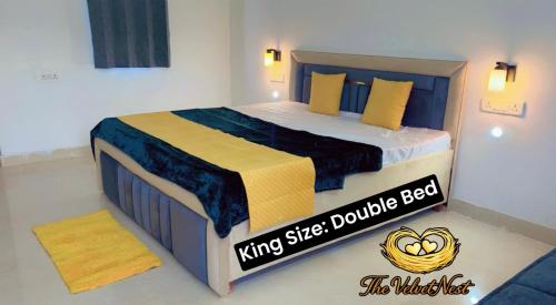a bedroom with a king size double bed with yellow pillows at The Velvet Nest - Gurgaon - Luxurious Single Bedroom Private Villa with Garden in Gurgaon