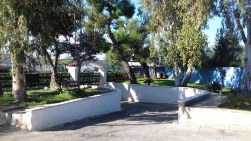 a park with trees and a white fence at i girasoli srls in Bari