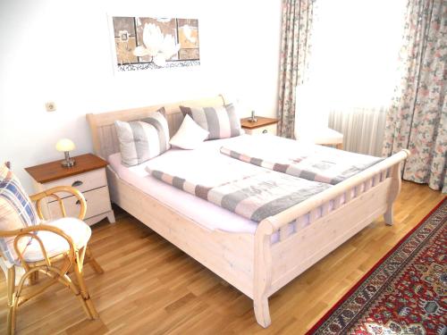 a bedroom with a bed and a table and a chair at Ferienwohnung Edmeier in Bernau am Chiemsee
