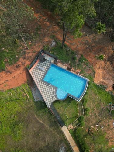 an overhead view of a swimming pool in a yard at Kashmeeram Vythiri Wayanad Premium Pool Resort in Vayittiri
