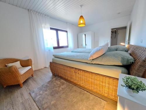 a bedroom with a bed and a chair at Ferienwohnung Wandelweg in Kamp-Lintfort