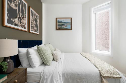 a bedroom with a white bed and a window at Spacious 2BR near UofT and College in Toronto