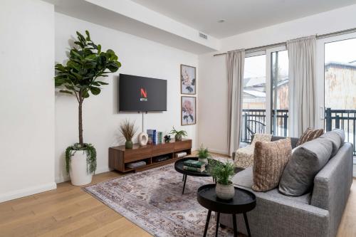 a living room with a couch and a tv at Spacious 2BR near UofT and College in Toronto