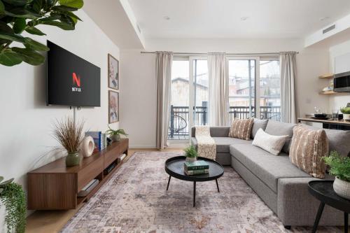 a living room with a couch and a table at Spacious 2BR near UofT and College in Toronto