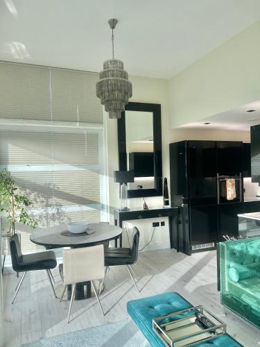 a dining room with a table and chairs at Cloud Nine Luxe Apartment in London