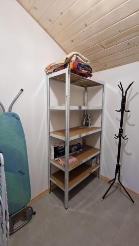 a shelf in a room with a wooden ceiling at CHATKA u TADKA in Nowy Sącz