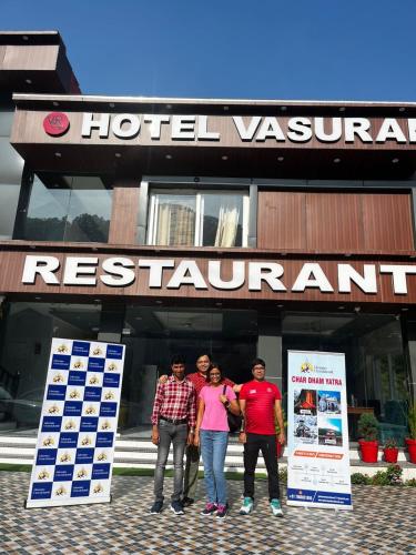 a group of people standing in front of a hotel restaurant at Hotel vasurai and restaurant in Nākuri