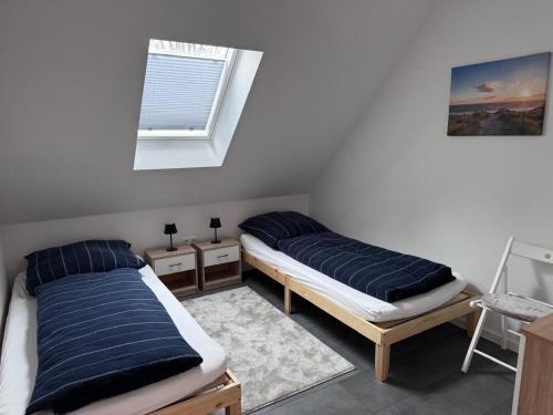 a bedroom with two beds and a window at Ferienwohnung Schöne Aussicht in Hinte