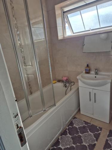 a bathroom with a shower and a sink at 83 Clonmullion Athy county Kildare in Athy