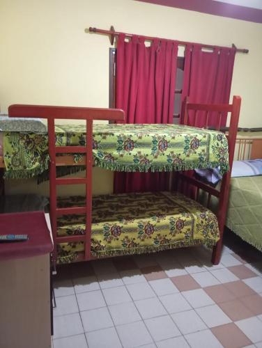 a room with a bench in a room at Hostal Mechita Mamani in Cafayate