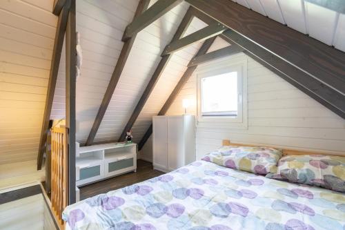 a bedroom with a bed in a attic at Hacienda-Dębina in Debina