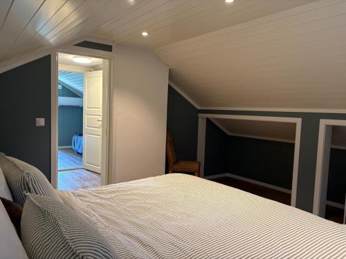 a bedroom with a bed and a door to a hallway at Toppen House in Ringsaker