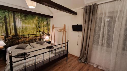 a bedroom with a bed and a large window at Apartmán 4you in Buchlovice