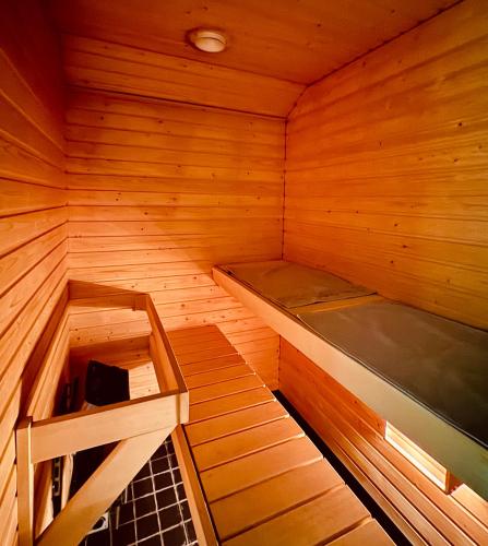 an empty wooden sauna with a bed in it at Modern Two-Bedroom Apartment with Sauna & Free Parking in Turku