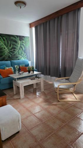 a living room with a couch and a table at Casa Arena Negra Edificio A'costa in Puerto Naos