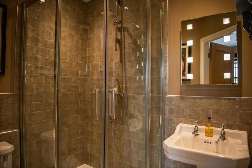 a bathroom with a shower and a sink at Blue Bell Country Inn in Knaresborough
