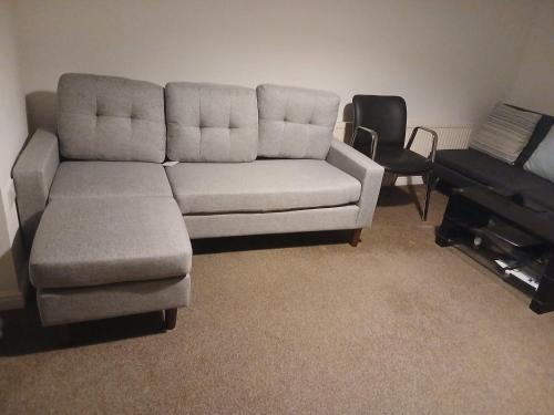 a couch and a chair in a living room at Double room Thornaby train station in Stockton-on-Tees
