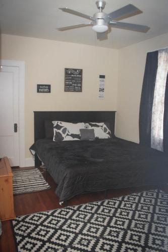 a bedroom with a bed with a ceiling fan at Charming 1 BR Apt 6 miles from Downtown! in Cincinnati