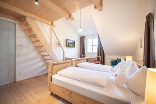 a bedroom with a large bed and a staircase at Hotel Kabis in Funes