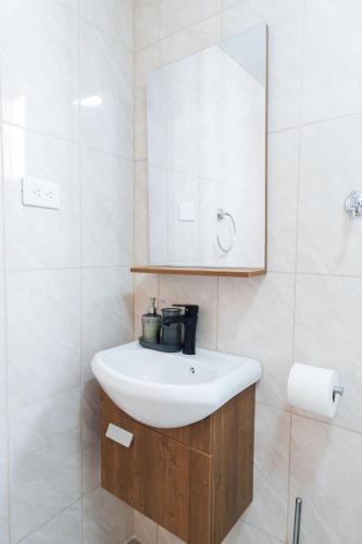 a bathroom with a white sink and a mirror at SoliMar Caribeño in Boca Chica