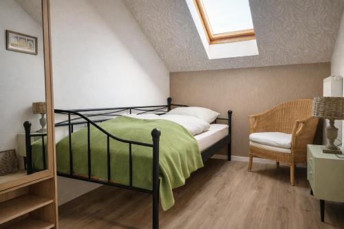 a bedroom with a bed and a skylight at Waldpanorama Schildberg in Lügde