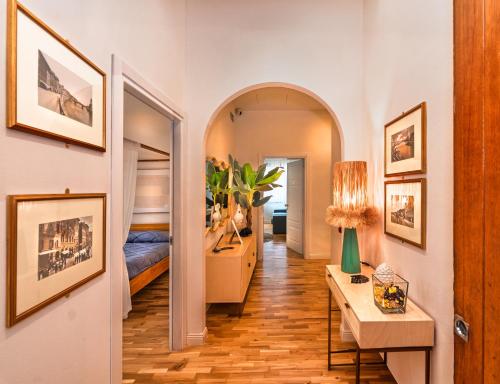 a hallway with a room with a bed and a table at RELAIS DELL'USSERO Pisa centro in Pisa