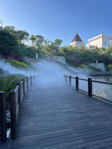a wooden boardwalk with steam coming out of the water at Vidanta World in Jarretadera