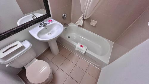 a bathroom with a sink and a toilet and a sink at Econo Lodge City Centre in Kingston