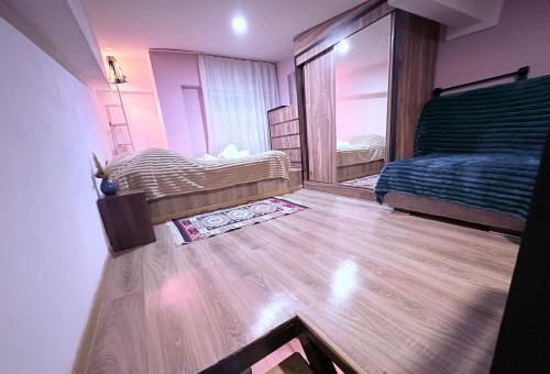 a bedroom with two beds and a wooden floor at Old Tbilisi in Tbilisi City