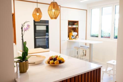 a kitchen with a bowl of fruit on a counter at Madeira Precious Family Apartment in Funchal