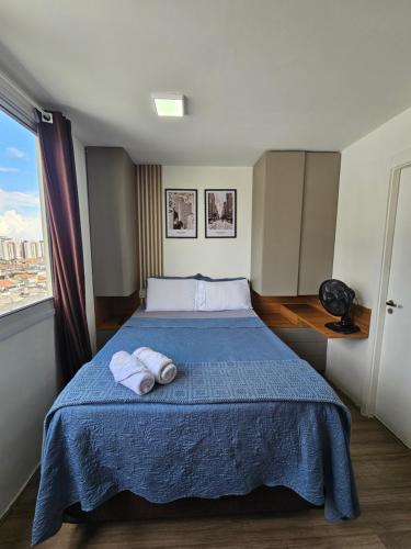 a bedroom with a bed with two towels on it at 200m metro bras com Piscina in São Paulo
