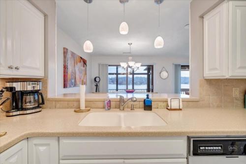 a kitchen with a sink and a counter top at Lake Vibes - Pet Friendly Lakefront Condo! in Moneta