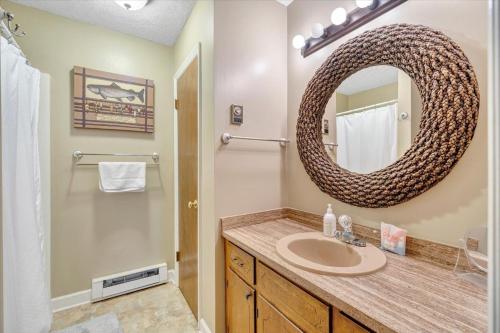 a bathroom with a sink and a mirror at Summer Breeze - Lakefront w/ Private Dock! in Moneta