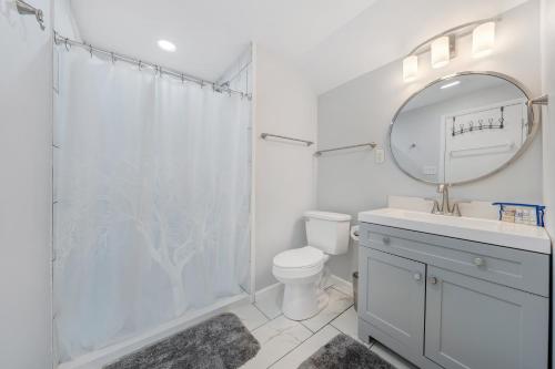 a bathroom with a shower and a toilet and a mirror at Sundance - Lakefront w/ Private Dock in Moneta