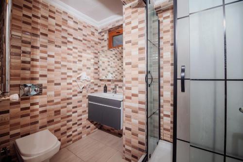 a bathroom with a toilet and a sink and a shower at White Moon Suites in Istanbul